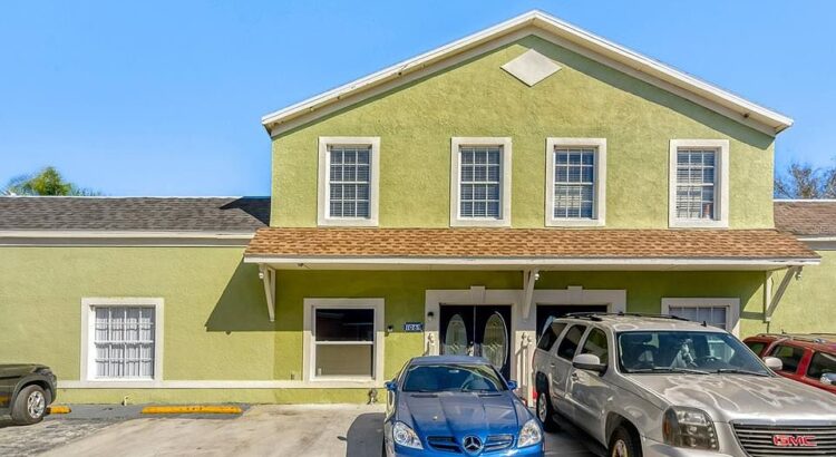 Exterior view of a building with parked cars in front